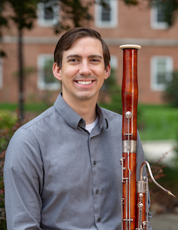 Headshot of Joseph Grimmer with his bassoon