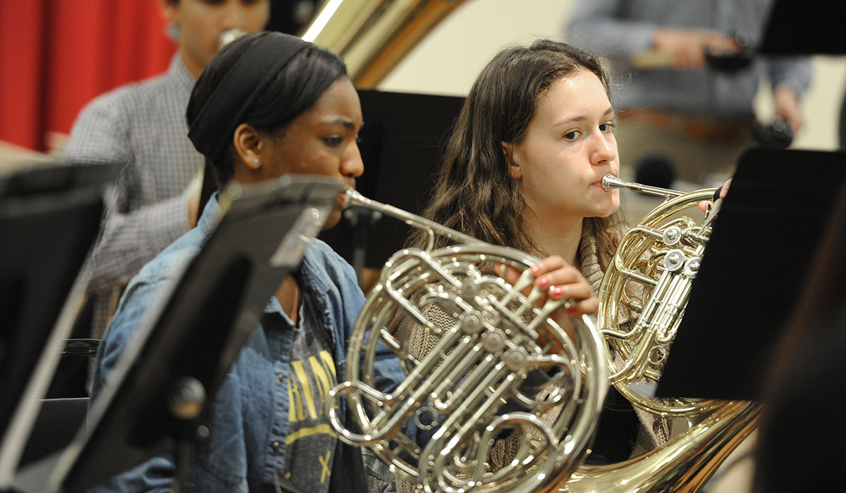 Student playing French horn
