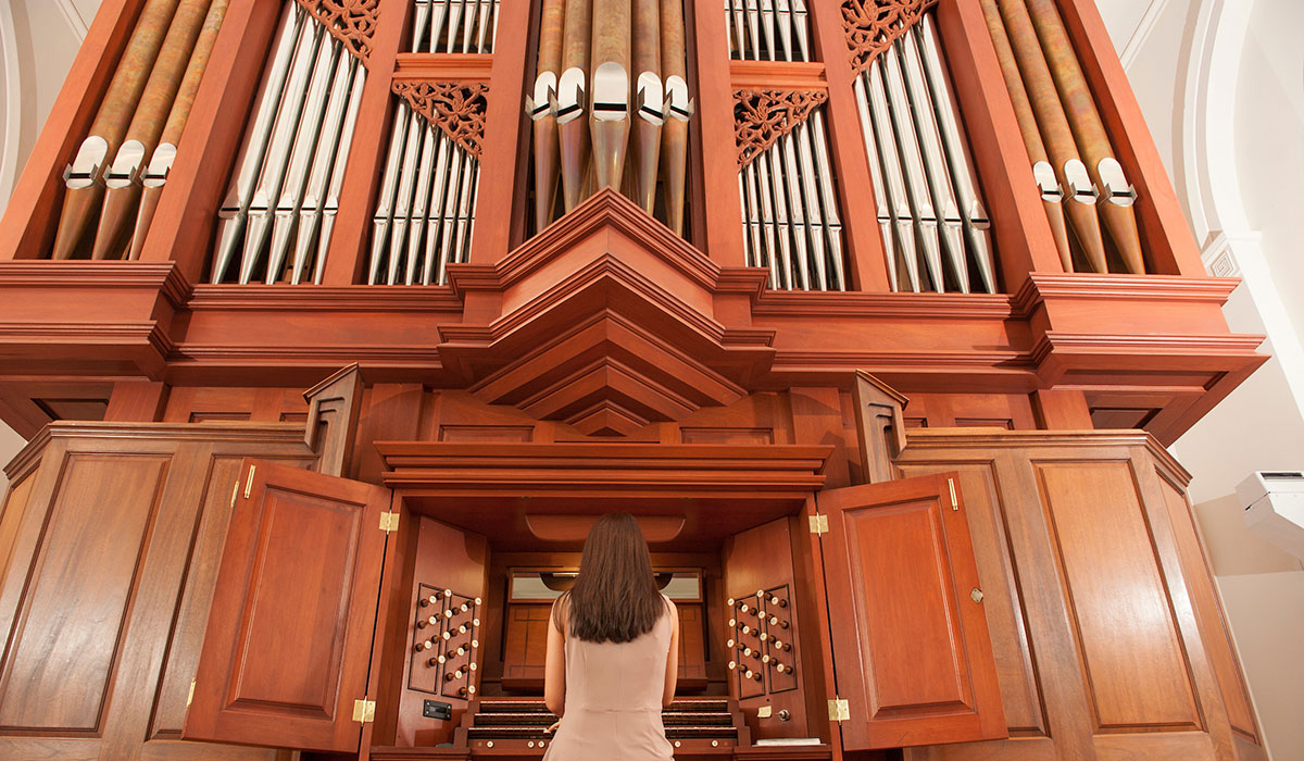 Student playing organ